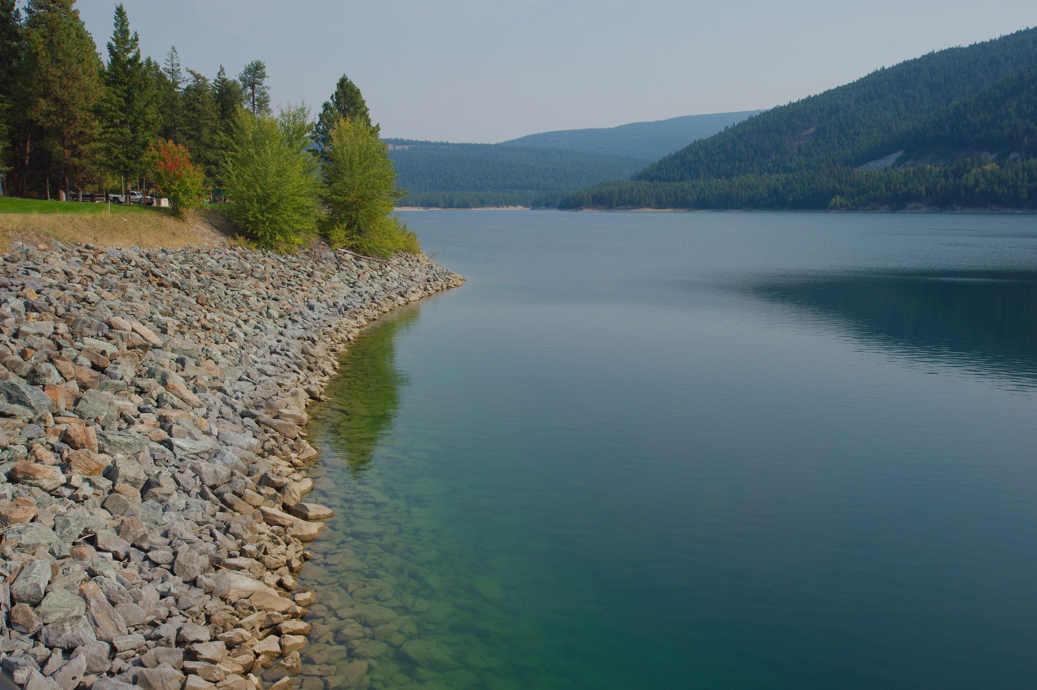 Mountain lake landscape in northwest Montana—closed-cell spray foam supports cold-climate energy efficiency.
