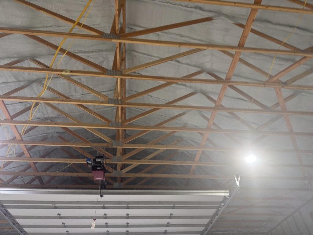 Closed-cell spray foam insulation being applied inside a shop building in Kalispell Montana.