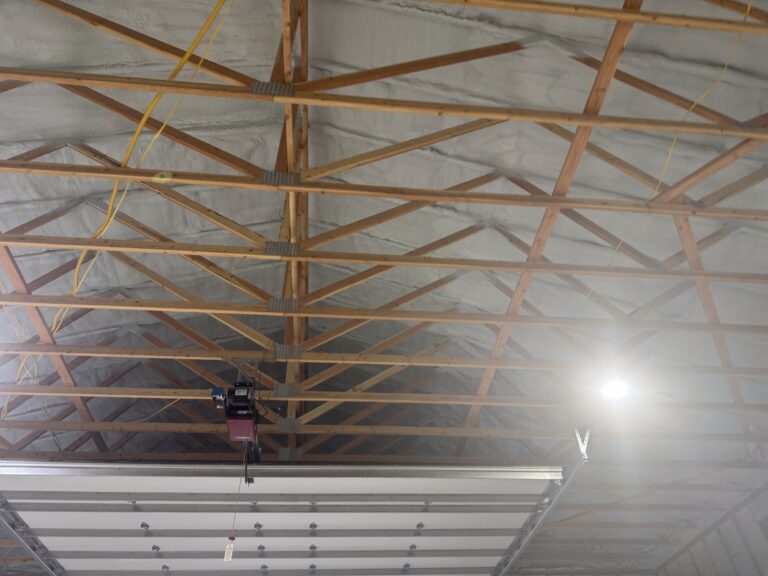 Closed-cell spray foam insulation being applied inside a shop building in Kalispell Montana.