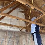 Closed-cell spray foam insulation being applied in wall cavity in Kalispell Montana home