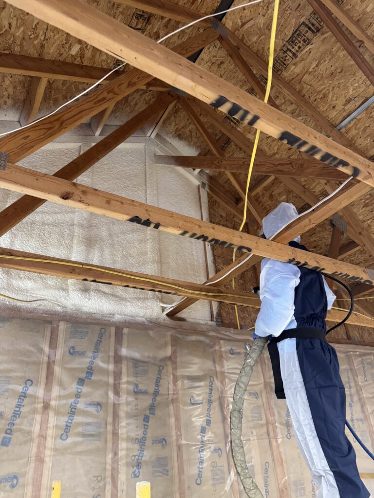 Closed-cell spray foam insulation being applied in wall cavity in Kalispell Montana home